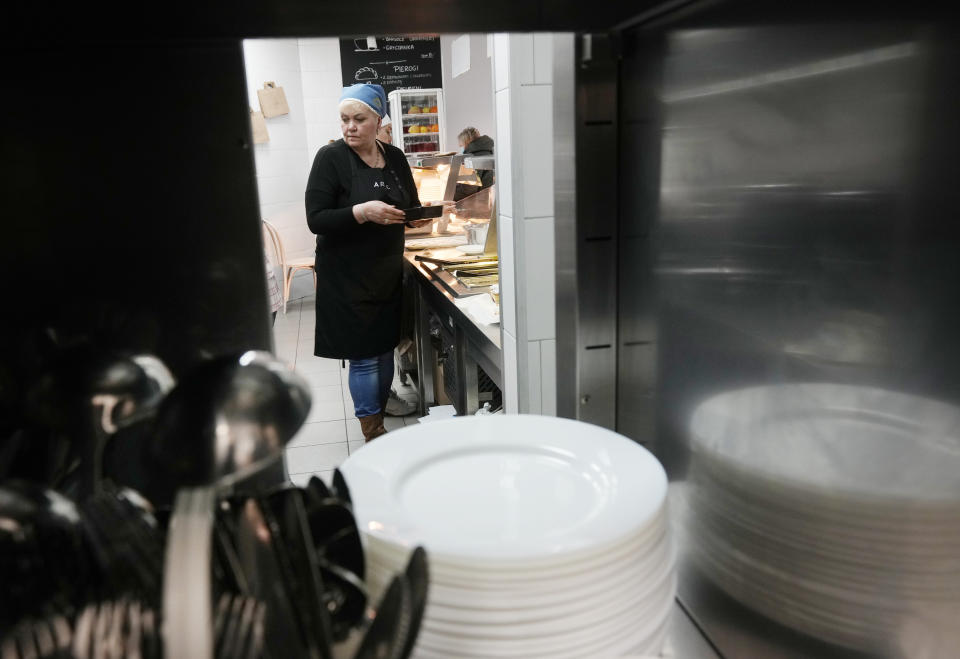 Ukrainian refugee women working at a Ukrainian food bar that a private foundation has opened to offer jobs to the refugees, in Warsaw, Poland, on Friday, April 1, 2022. Having escaped from Russian shelling, Ukrainian refugees are now focused on building new lives — temporarily or permanently. Countries neighboring their homeland, like Poland and Romania, are sparing no effort to help them integrate and feel needed in the new environment. (AP Photo/Czarek Sokolowski)