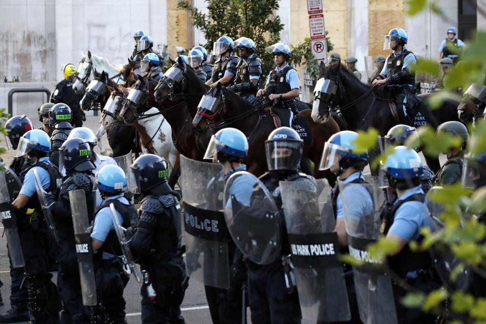 Police clear the area around Lafayette Park and the White House as demonstrators gather to protest the death of George Floyd, Monday, June 1, 2020, in Washington. Floyd died after being restrained by Minneapolis police officers. (AP Photo/Alex Brandon)