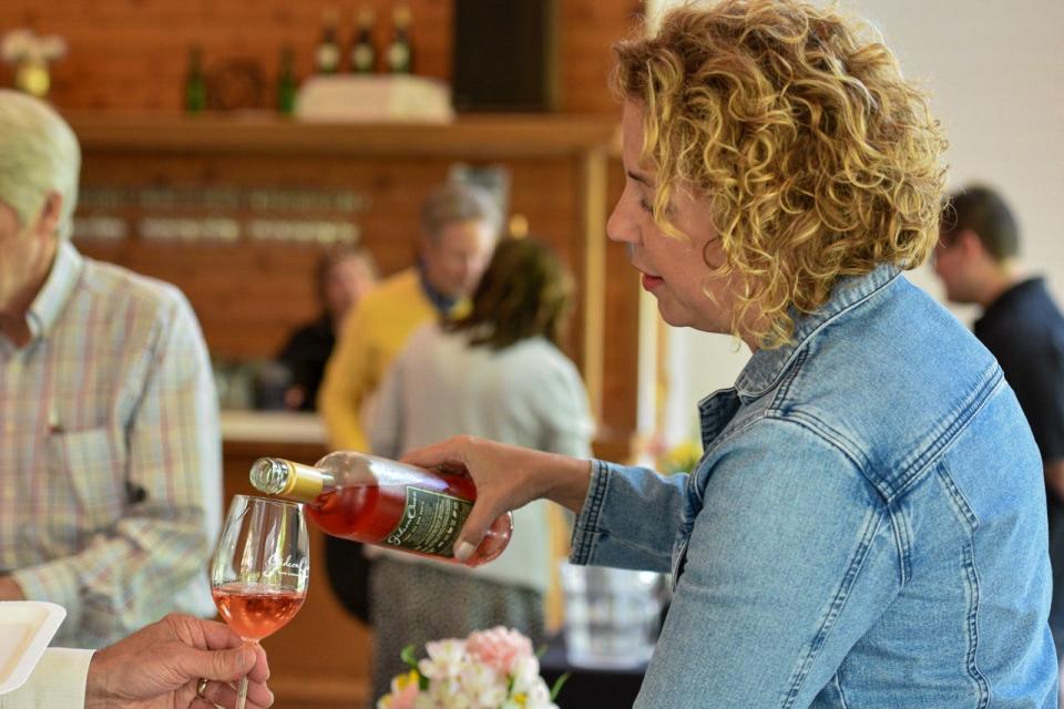 Monica Verhoff of Verhoff Family Vineyards pours a glass of Chardonel, the first wine produced on the Gideon Owen property in over 40 years, during Uncorked on May 19. The Verhoff Family Vineyards produced many of the grapes used in Gideon Owen’s new wines.