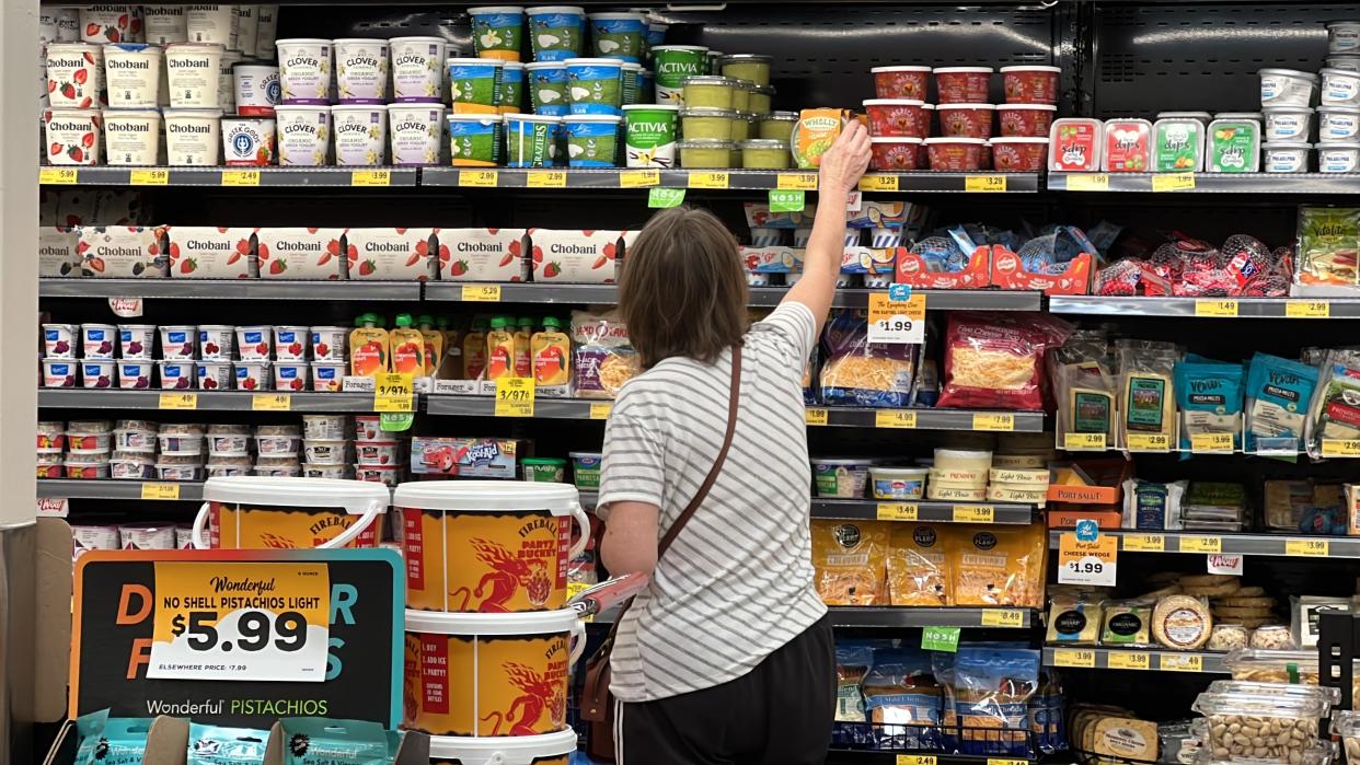 A customer looks at refrigerated items at a Grocery Outlet store in Pleasanton, Calif.,. on Thursday, Sept. 15, 2022. "Best before” labels are coming under scrutiny as concerns about food waste grow around the world. Manufacturers have used the labels for decades to estimate peak freshness. But “best before” labels have nothing to do with safety, and some worry they encourage consumers to throw away food that’s perfectly fine to eat. (AP Photo/Terry Chea)