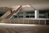 A worker walks down the stairs from the departures area to the arrivals greeting area of the newly built airport in Islamabad, Pakistan May 6, 2017. REUTERS/Caren Firouz