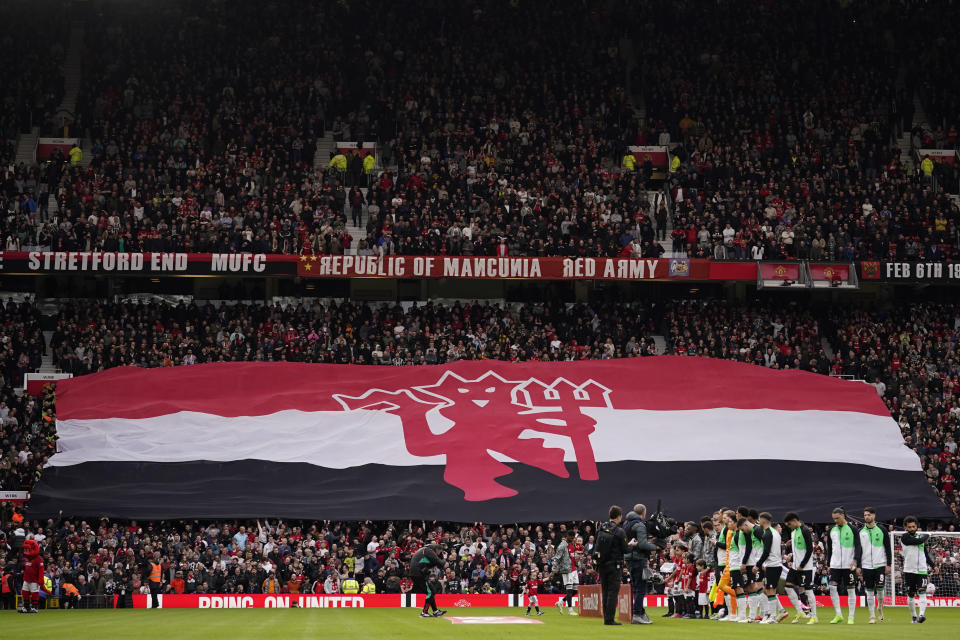 A giant flag is displayed on the stands before the FA Cup quarterfinal soccer match between Manchester United and Liverpool at the Old Trafford stadium in Manchester, England, Sunday, March 17, 2024. (AP Photo/Dave Thompson)