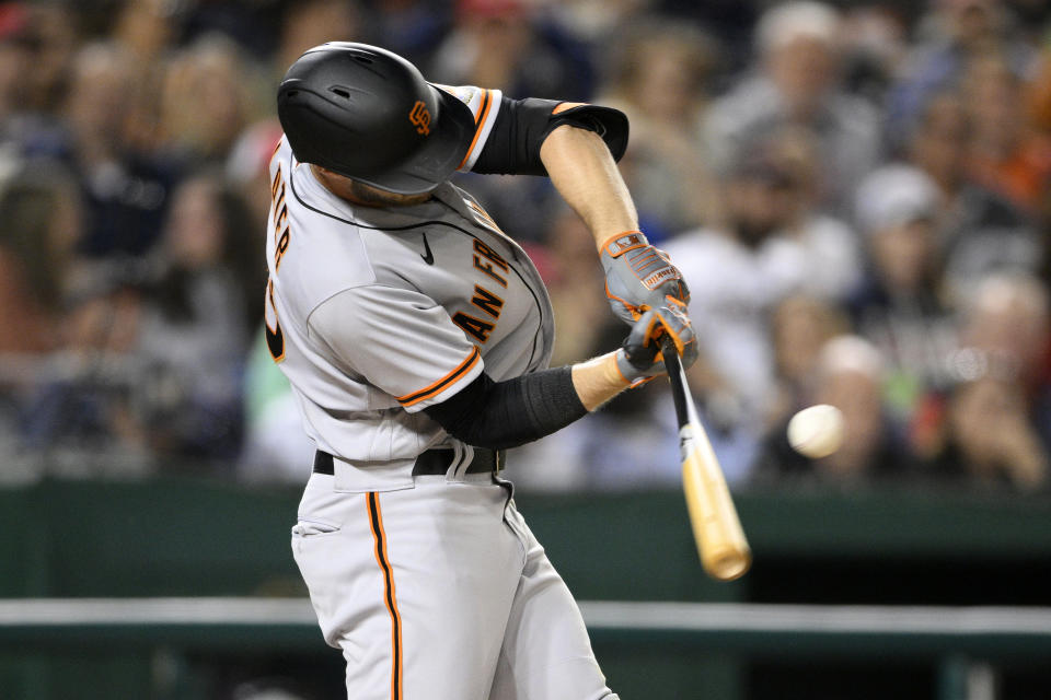 San Francisco Giants' Austin Slater singles during the third inning of the team's baseball game against the Washington Nationals, Friday, April 22, 2022, in Washington. (AP Photo/Nick Wass)