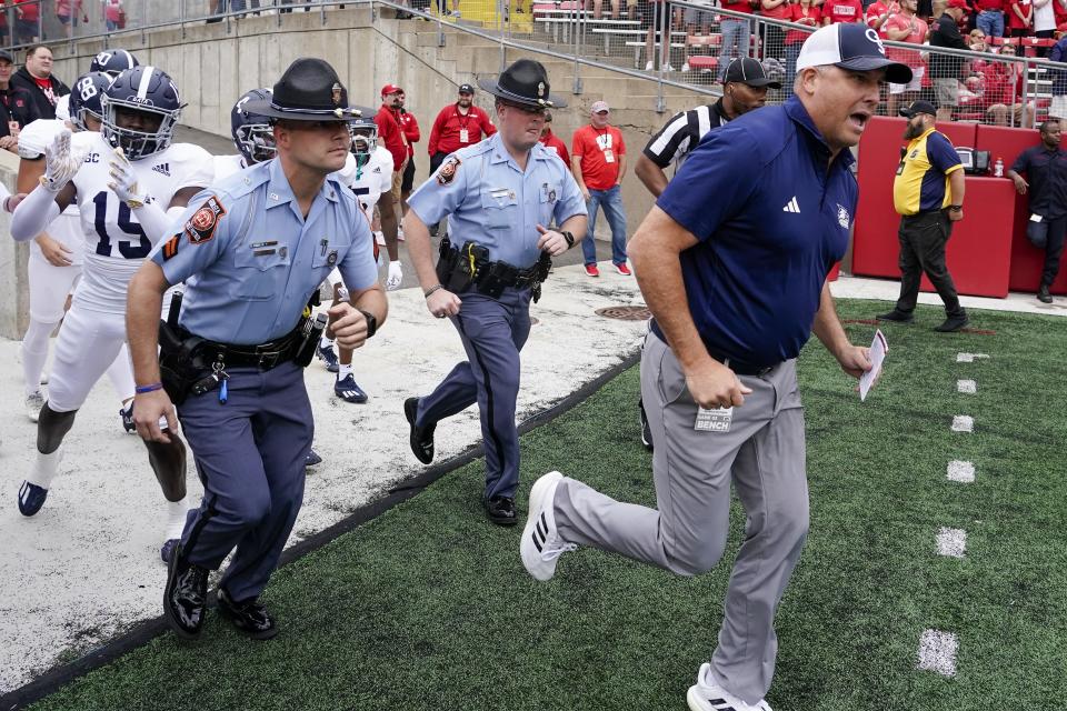 Georgia Southern head coach Clay Helton leads his team to the field before an NCAA college football game against Wisconsin Saturday, Sept. 16, 2023, in Madison, Wis. (AP Photo/Morry Gash)