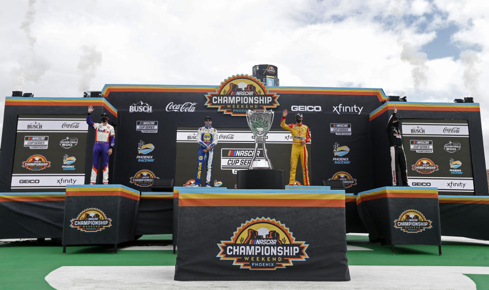 The Championship 4 drivers, from left to right, Denny Hamlin, Chase Elliott, Joey Logano and Brad Keselowski wave to the crowd during driver introductions prior to a NASCAR Cup Series auto race at Phoenix Raceway, Sunday, Nov. 8, 2020, in Avondale, Ariz. (AP Photo/Ralph Freso)