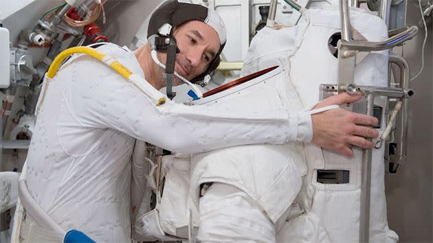 Parmitano performs routine checks on his spacesuit. Photo: AP