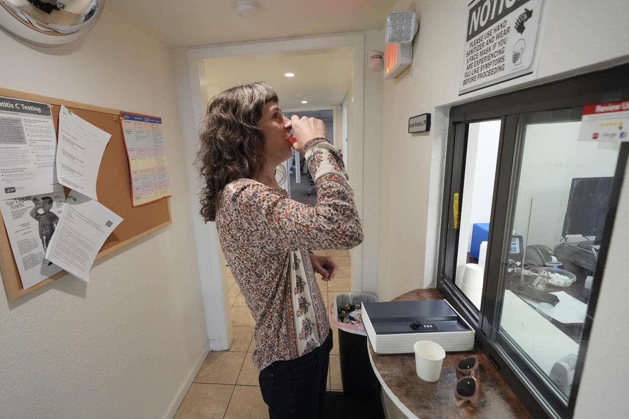 Methadone patient Irene Garnett, 44, of Phoenix, takes her treatment at a clinic in Scottsdale, Ariz., on Monday, Aug. 26, 2024. (AP Photo/Ross D. Franklin)