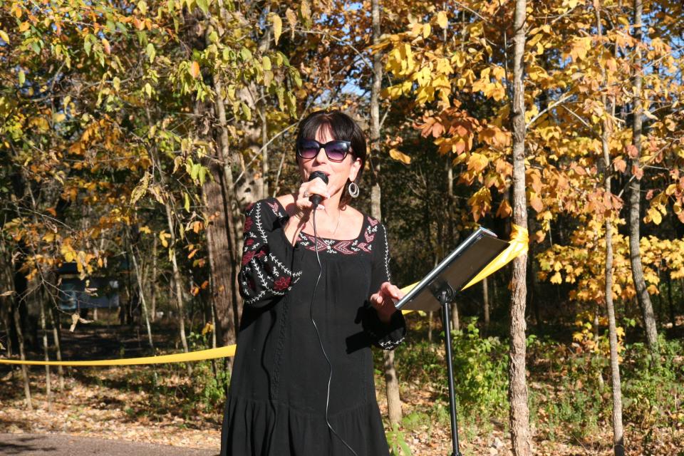 Carol Evans, director of the Legacy Parks Foundation, addresses the crowd at the dedication of the Storybook Trail at Collier Preserve. Nov. 2022