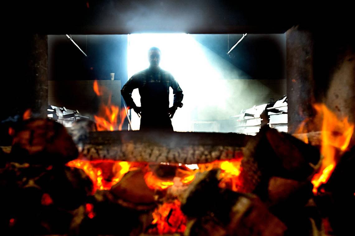 Sam Jones, owner of the Sam Jones BBQ in Winterville and Raleigh checks the coals at the Winterville location.