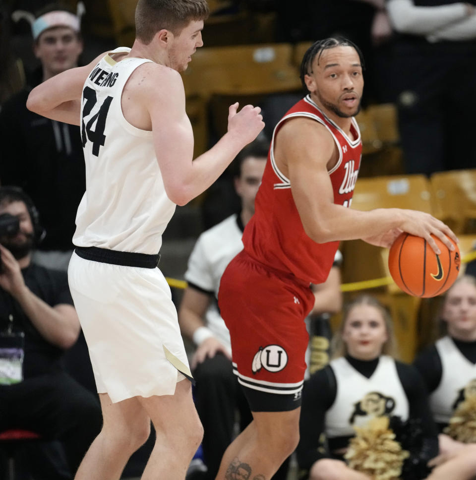 Utah guard Marco Anthony, right, pulls in the ball as Colorado center Lawson Lovering defends in the first half of an NCAA college basketball game Saturday, March 4, 2023, in Boulder, Colo. (AP Photo/David Zalubowski)