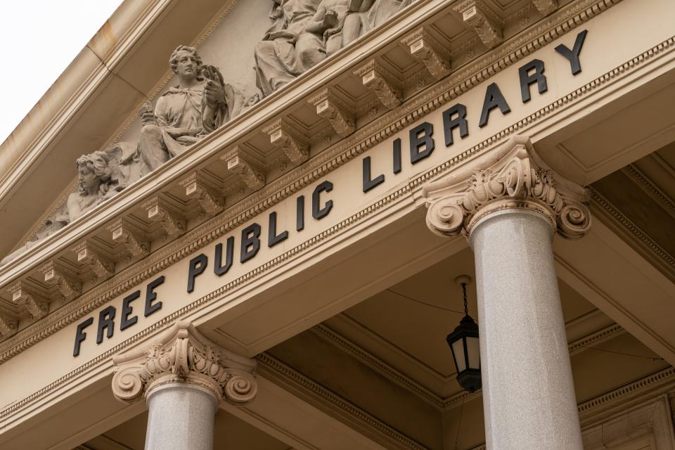 The New Brunswick Free Public Library is an example of the Beaux Arts Style: the use of stone materials, a focus on symmetry, statues within the façade, and four Ionic granite columns.