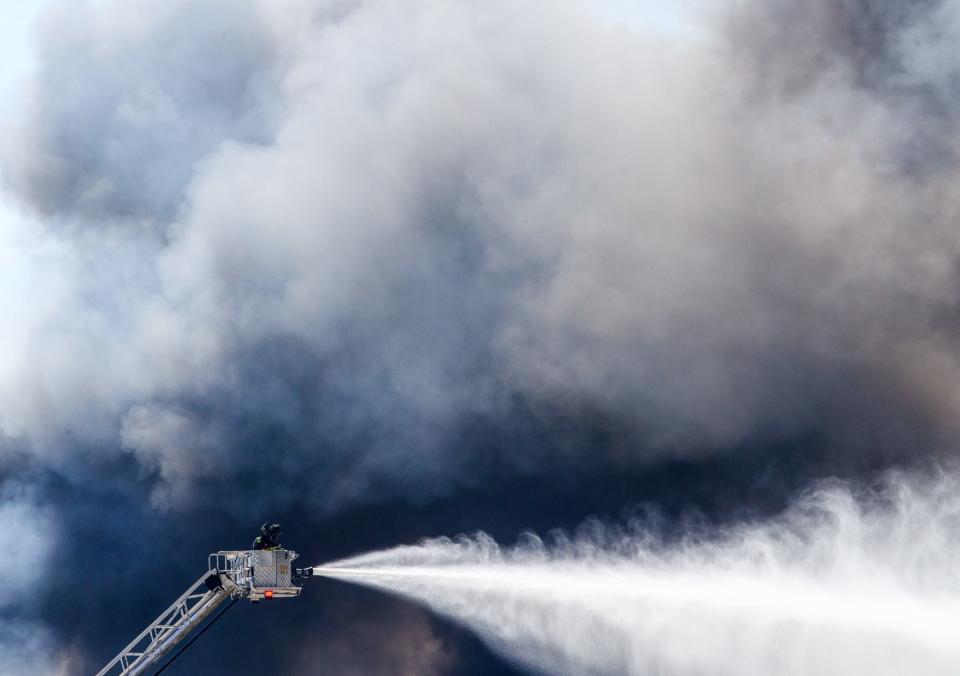 A massive fire burns inside a Walmart fulfillment center in Plainfield, Ind., near the Indianapolis International Airport.