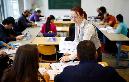 Migrants attend a lesson at the "institute for intercultural communication" in Berlin, Germany, April 13, 2016. REUTERS/Hannibal Hanschke