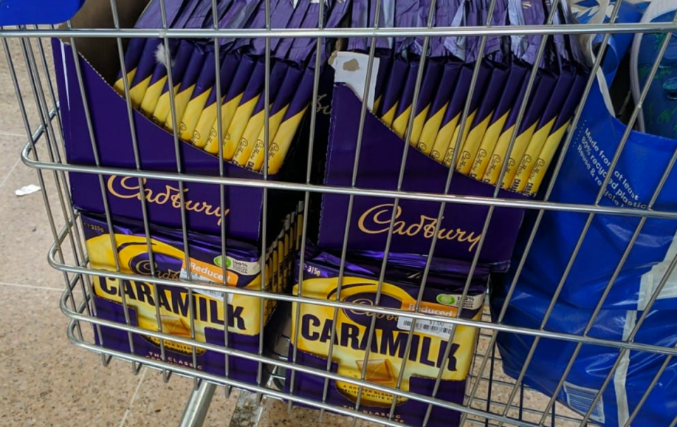 Cadbury Caramilk chocolate blocks filling a trolley at Big W