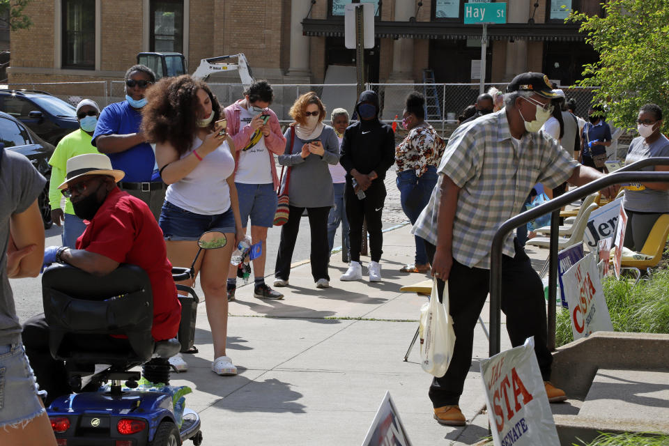 Residents wait in line outside the Wilkinsburg Municipal Building to cast their vote during primary voting, in Pittsburgh, Tuesday, June 2, 2020. (AP Photo/Gene J. Puskar)