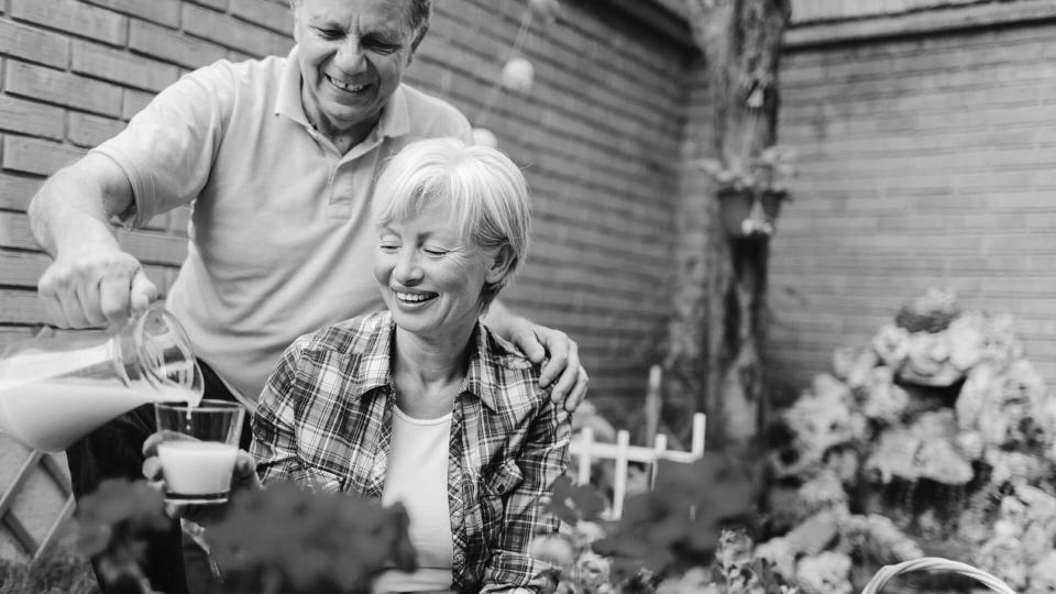 older couple having drinks in the garden