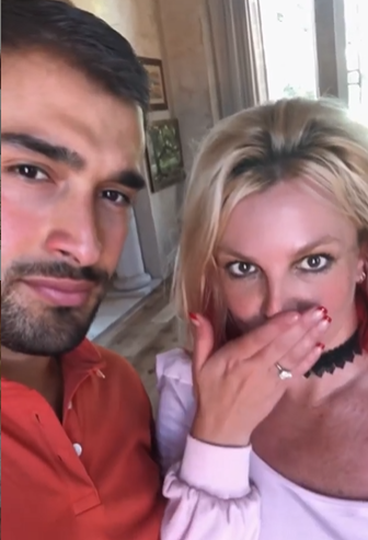 Singer Britney Spears shows off her engagement ring with fiancé Sam Asghari.
