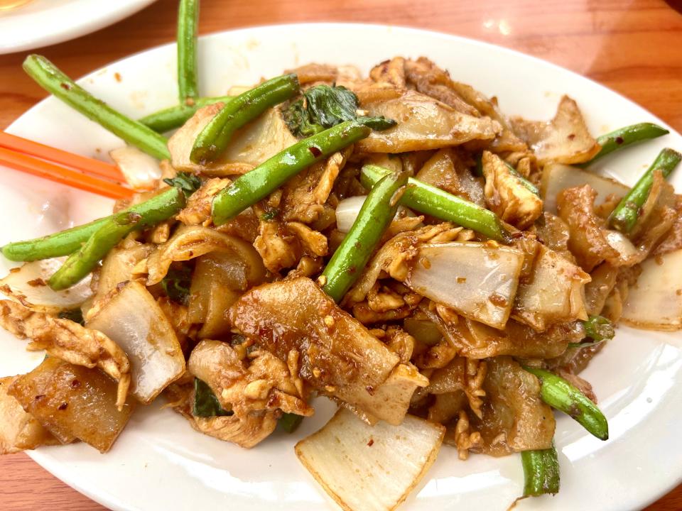 Mekong Cafe's pud kee mow features wide rice noodles served with crisp-tender green beans, onions and fresh holy basil.