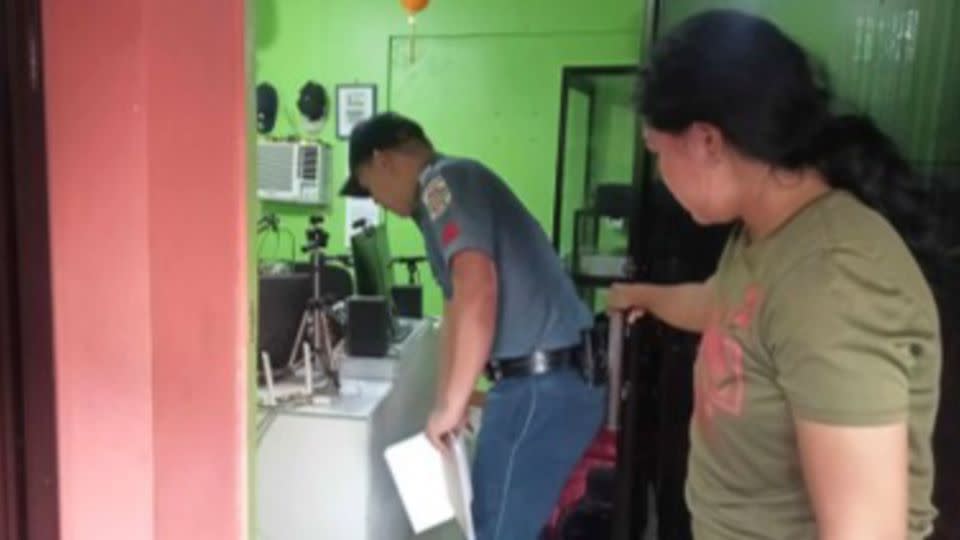 A police officer checks the area where a radio anchor was fatally shot at his home-based station in Calamba, Misamis Occidental province, southern Philippines on November 5, 2023. - Calamba Municipal Police Station/AP