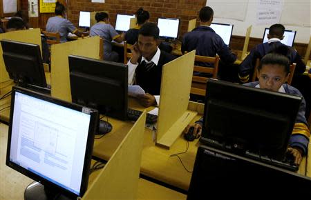 Students use computers to study at Elswood Secondary School in Cape Town November 7, 2013. REUTERS/Mike Hutchings