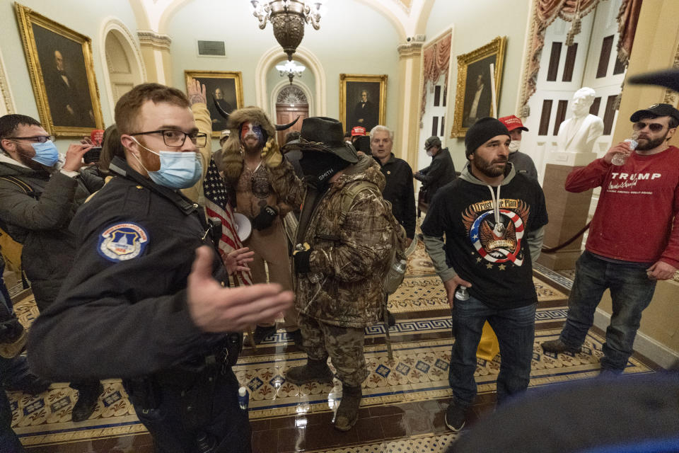 Supporter of President Donald Trump are confronted by Capitol Police officers outside the Senate Chamber at the Capitol, Wednesday, Jan. 6, 2021 in Washington.  (AP Photo/Manuel Balce Ceneta)