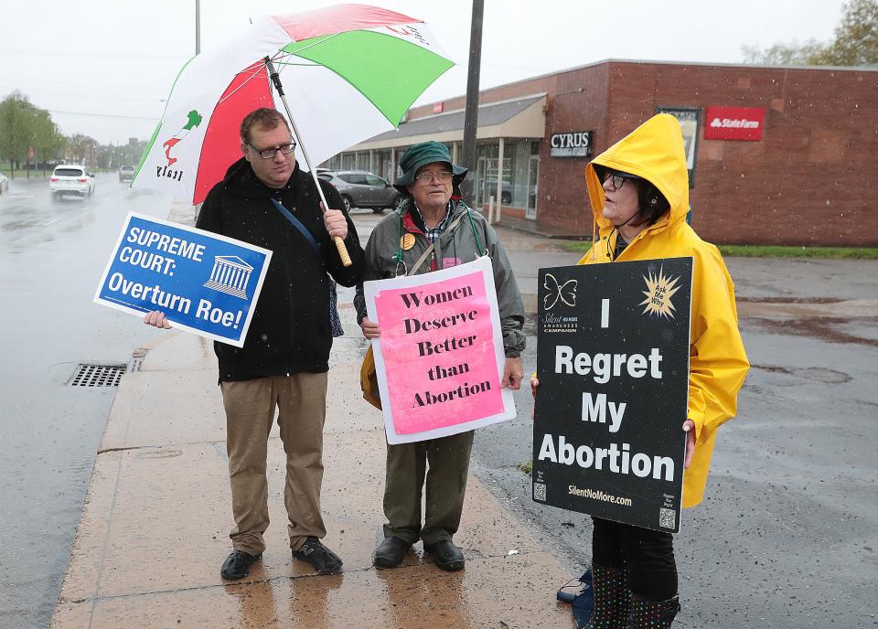 Abortion protestors outside Planned Parenthood of Canton are Paul Crowley,left, Gary Cerrone, and Christy Ballor .