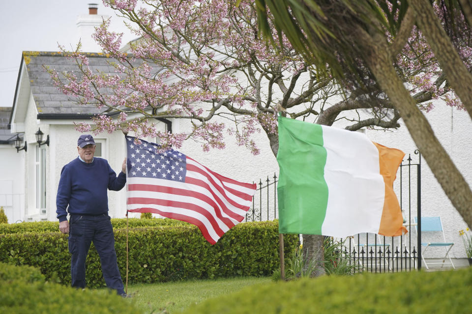 Ambrose Carroll flies the national flag of the United States of America and the Irish national flag in his garden in Whitestown, near Carlingford in Co Louth, close to Kilwirra cemetery, where the relatives of US President Joe Biden are buried, ahead the President's visit to the island of Ireland, Tuesday April 11, 2023. (Niall Carson/PA via AP)