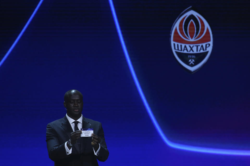 Ivorian coach and former player Yaya Toure shows the name of FC Shakhtar Donetsk during the soccer Champions League draw in Istanbul, Turkey, Thursday, Aug. 25, 2022. (AP Photo/Emrah Gurel)