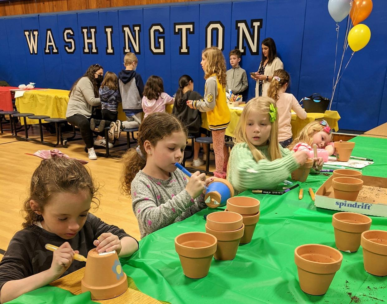 Washington Elementary School students decorated and potted plants for local senior citizens as part of Community Service Night on Thursday, March 24.