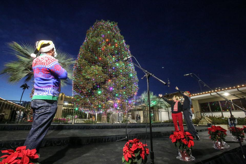 Indio City Council members Glenn Miller and Elaine Holmes initiate the light of the City of Indio's Christmas tree as host Jim Curtis, left, looks on Saturday, December 1, 2018 in Indio. 