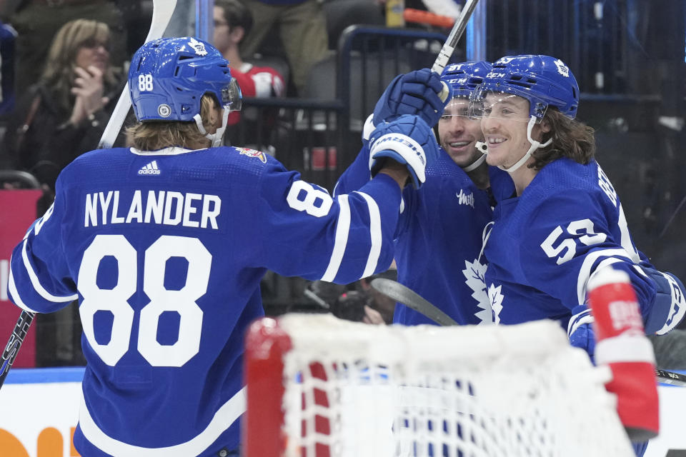 Toronto Maple Leafs' Tyler Bertuzzi, right, celebrates with John Tavares, center, and William Nylander after scoring against the Ottawa Senators during the second period of an NHL hockey game in Toronto, on Wednesday, Nov. 8, 2023. (Chris Young/The Canadian Press via AP)