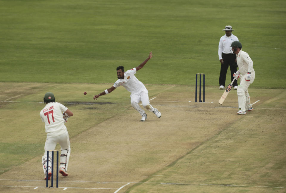 Sri Lanka bowler Suranga Lakmal, centre, attempts but fails a catch, during the test cricket match against Zimbabwe at Harare Sports Club, Sunday, Jan, 19, 2020. Zimbabwe won the toss and elected to bat in its first match since the International Cricket Council lifted the country's ban last year. (AP Photo/Tsvangirayi Mukwazhi)