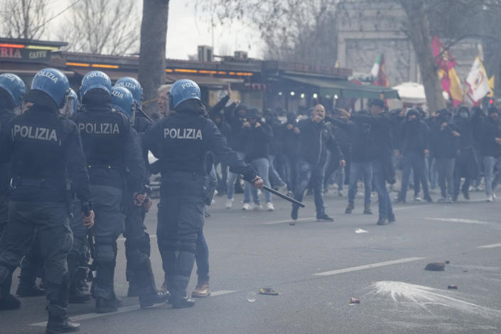 Roma fans riot with police ahead the Italian Serie A soccer match between Lazio and Roma at Rome's Olympic stadium, Sunday, March 19, 2023. (AP Photo/Gregorio Borgia)