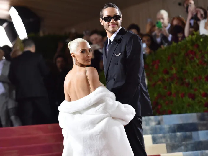 kim kardashian and pete davidson connected  the steps astatine  the met gala, looking towards the side. kardashian is looking implicit    her shoulder, a achromatic  fur overgarment  hanging astir   her elbows, and davidson is wearing sunglasses