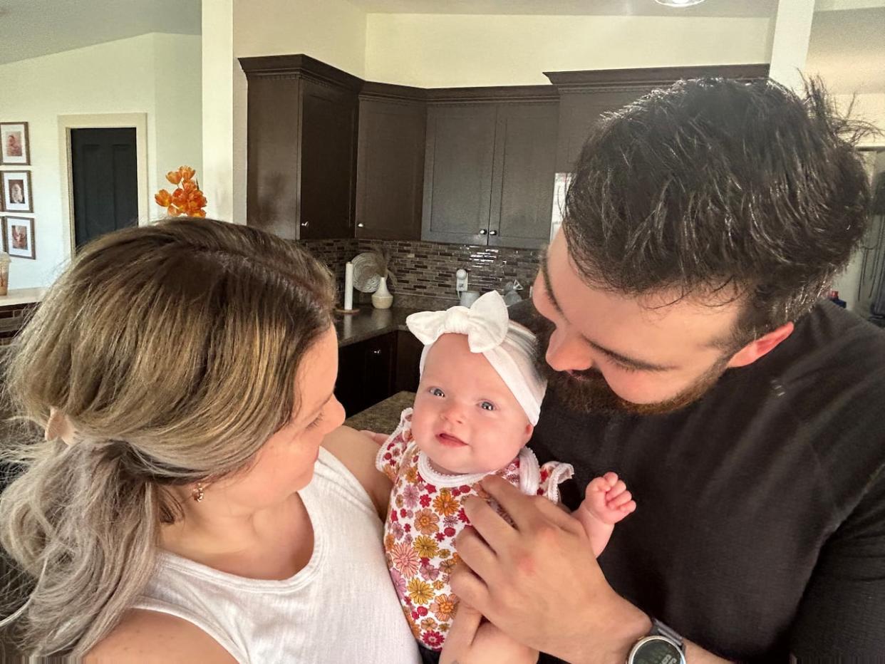 Sutton Ivy McCabe with her parents, Kennedie Ogden and Jesse McCabe, at their home.  (Submitted by the McCabe-Ogden family - image credit)