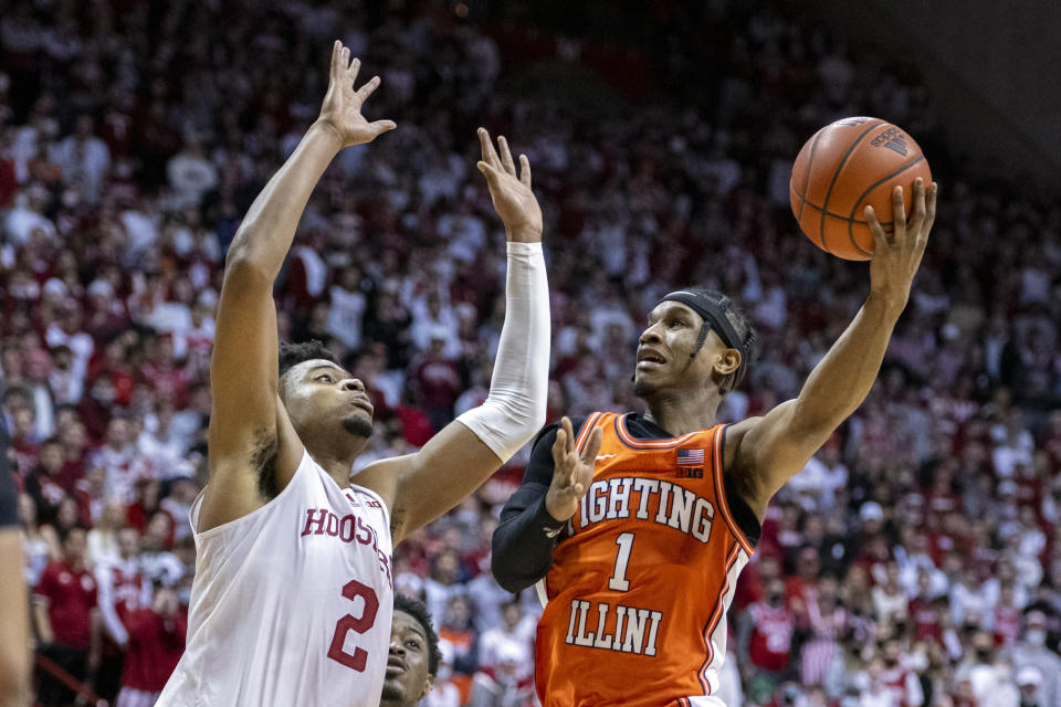 Illinois guard Trent Frazier (1) shoots while over Indiana center Michael Durr (2) during the first half of an NCAA college basketball game, Saturday, Feb. 5, 2022, in Bloomington, Ind. (AP Photo/Doug McSchooler)