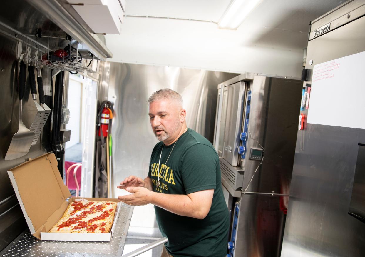 Owner Mike Galatioto boxes up Sicilian-style grandma pizza at New York Squares at the 45th Parallel Brewing, Friday, July 7, 2023, in Independence, Ore.
