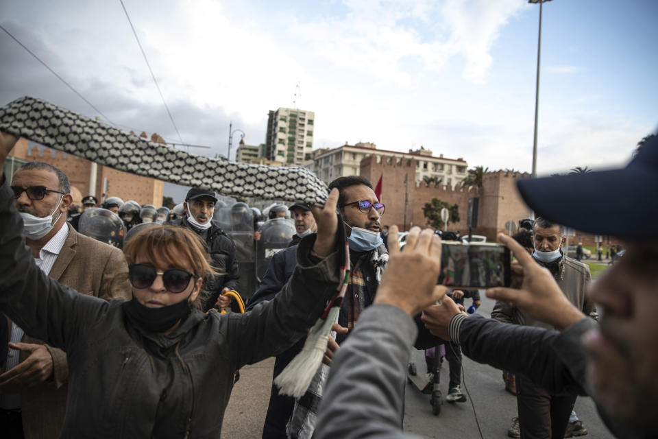 Protesters wave a Palestinian Kuffieyeh and chant slogans against the visit of Israeli Defence Minister Benny Gantz to Morocco, Wednesday, Nov. 24, 2021. Israel and Morocco signed a landmark agreement Wednesday that lays the foundation for security cooperation, intelligence sharing, and future arms sales. (AP Photo/Mosa'ab Elshamy)