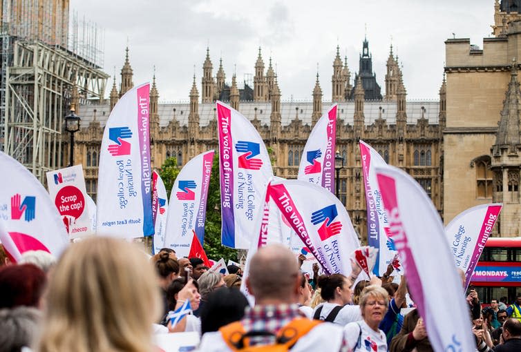 <span class="caption">Nurses gather at Parliament Square in London to campaign against the government’s 1% public sector pay cap.</span> <span class="attribution"><a class="link " href="https://www.shutterstock.com/download/confirm/714294907?src=37wX_tPz4Ta_4Eiup6dDPA-1-26&size=medium_jpg" rel="nofollow noopener" target="_blank" data-ylk="slk:John Gomez/Shutterstock.com;elm:context_link;itc:0;sec:content-canvas">John Gomez/Shutterstock.com</a></span>