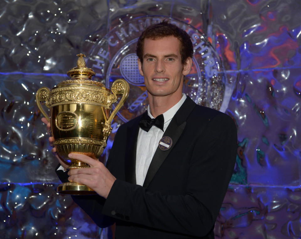 Andy Murray poses with the mens singles trophy during the Champions Ball at the Intercontinental Hotel, London.