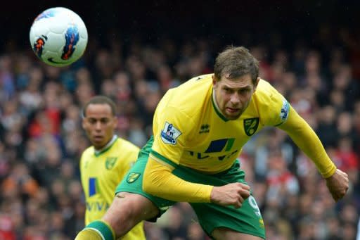 Norwich City striker Grant Holt heads the ball during the Premier League match against Arsenal at The Emirates Stadium in north London. Arsenal's bid for a top-four finish suffered a major setback as Steve Morison's late goal earned Norwich a deserved point in a six-goal thriller at the Emirates. The match ended 3-3