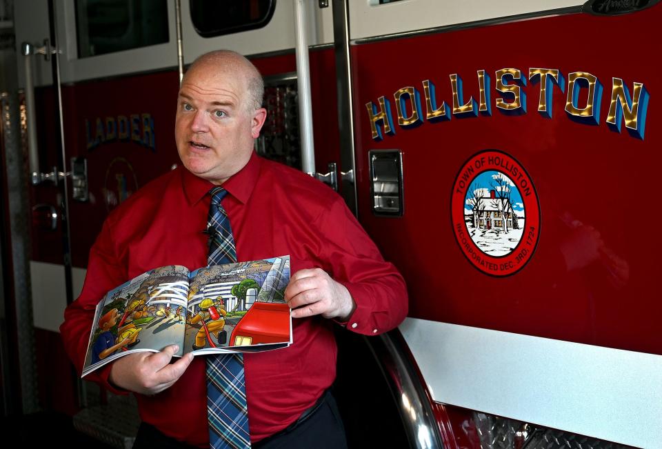 Holliston Fire Chief Michael Cassidy reads "Firefighter Nozzelhead Goes to Mexico" for his Holliston Cable Access Television (HCAT) program, "Story Time with Chief Cassidy," at the Central Street fire station, May 25, 2022.