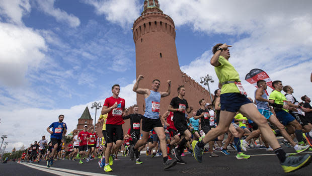 People run past the Kremlin Wall as they take part in a half-marathon in Moscow, Sunday, August, 2, 2020.  / Credit: Alexander Zemlianichenko Jr./AP