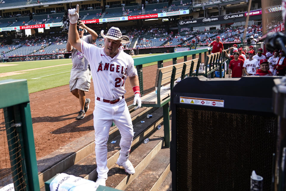 Los Angeles Angels center fielder Mike Trout (27) celebrates in the dugout after hitting a home run during the fifth inning of a baseball game against the Detroit Tigers in Anaheim, Calif., Wednesday, Sept. 7, 2022. (AP Photo/Ashley Landis)