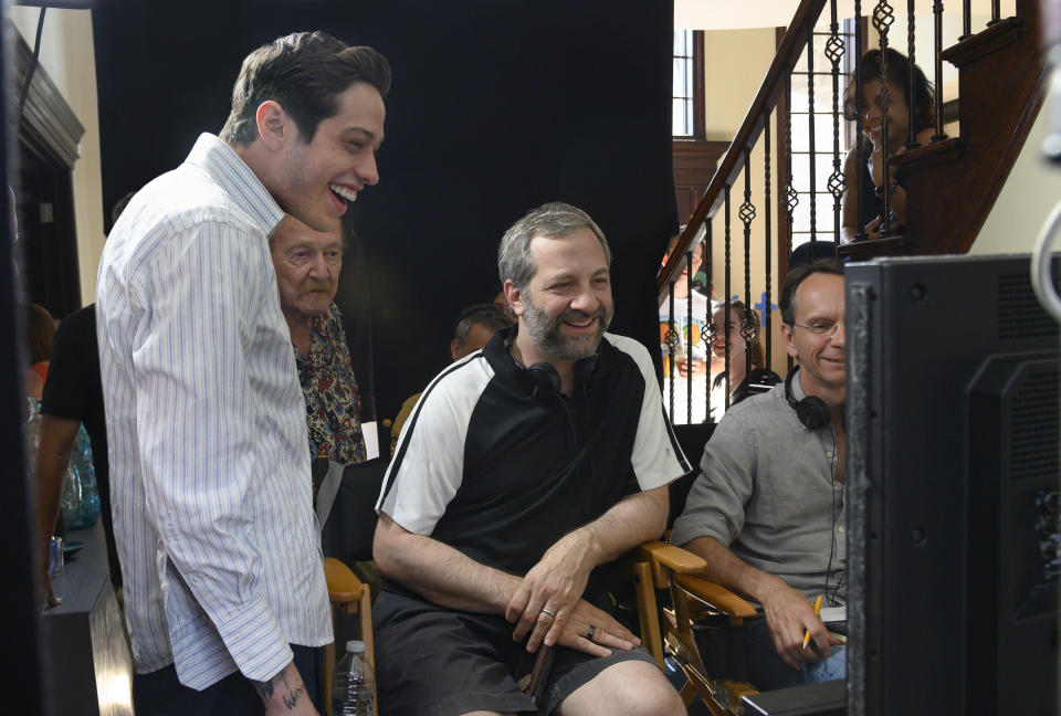 In this image released by Universal Pictures, Pete Davidson, left, appears with director Judd Apatow, center, during the filming of "The King of Staten Island." (Mary Cybulski/Universal Pictures via AP)