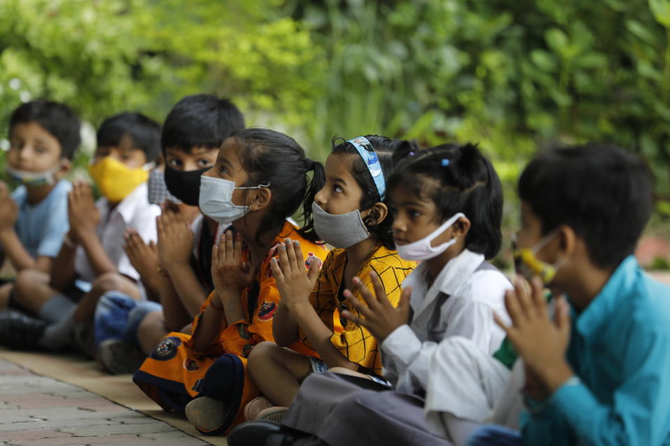 Students attend morning assembly on the first day of partial reopening of schools in Prayagraj, India, Wednesday, Sept. 1, 2021. More students in India will be able to step inside a classroom for the first time in nearly 18 months Wednesday, as authorities have given the green light to partially reopen more schools despite apprehension from some parents and signs that infections are picking up again. Schools and colleges in at least six more states will reopen in a gradual manner with health measures in place throughout September. (AP Photo/Rajesh Kumar Singh)