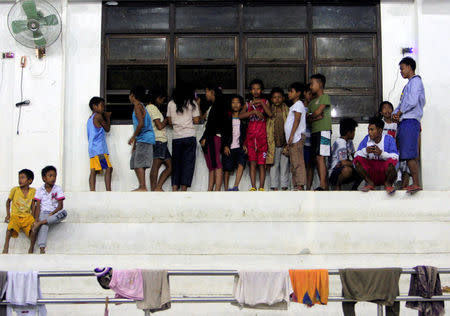 Evacuees from the coastal villages take shelter inside an evacuation center as Typhoon Haima locally name Lawin approaches, in Alcala town, Cagayan province, north of Manila October 19, 2016. REUTERS/Stringer