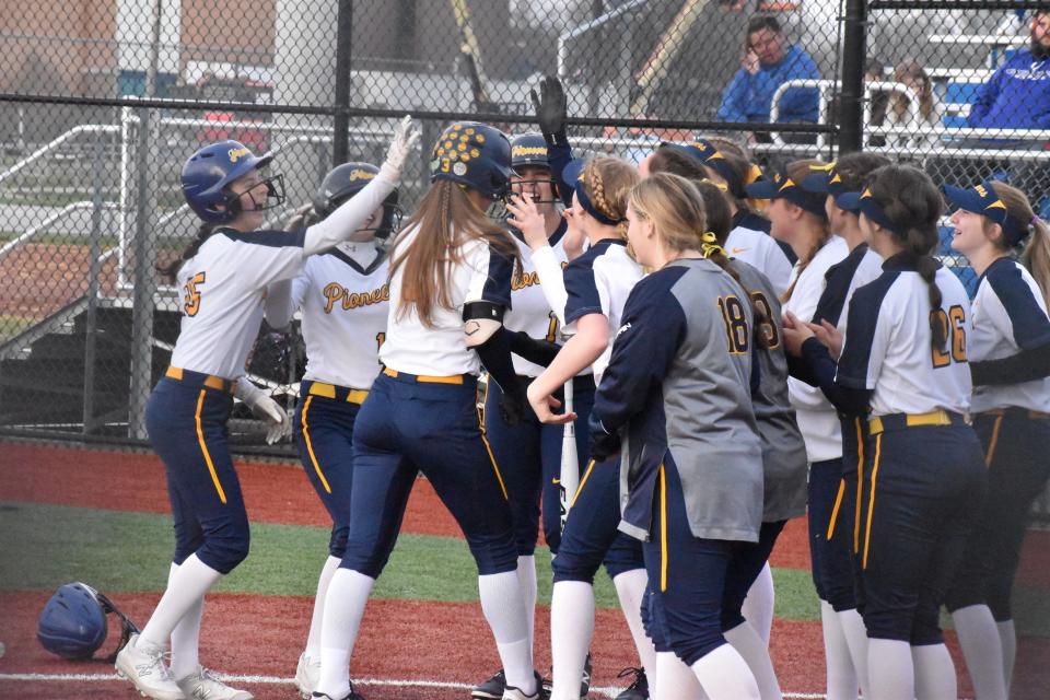 Mooresville players gather around to celebrate Alex Cooper's homerun hit during the Pioneers' rivalry matchup with Martinsville on April 5, 2022.