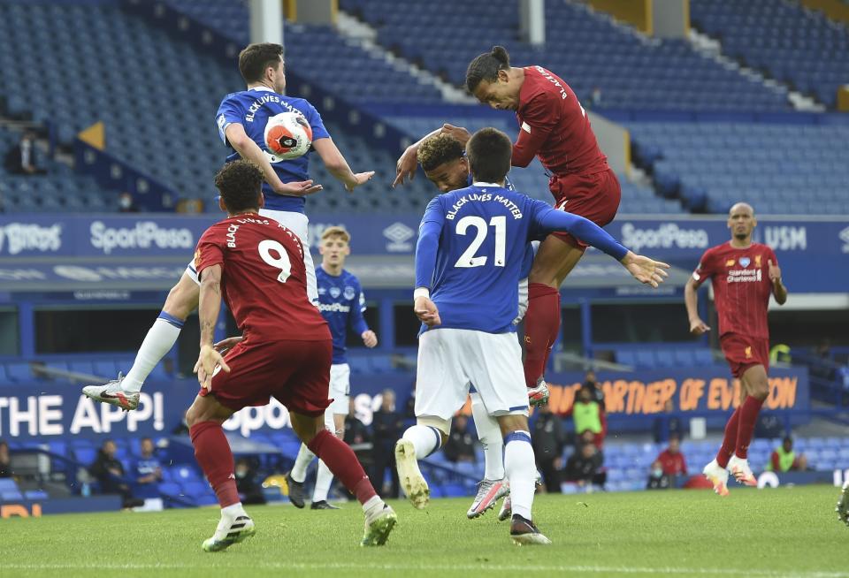 Liverpool's Virgil van Dijk, top right, gets in a header during the English Premier League soccer match between Everton and Liverpool at Goodison Park in Liverpool, England, Sunday, June 21, 2020. (Peter Powell/Pool via AP)