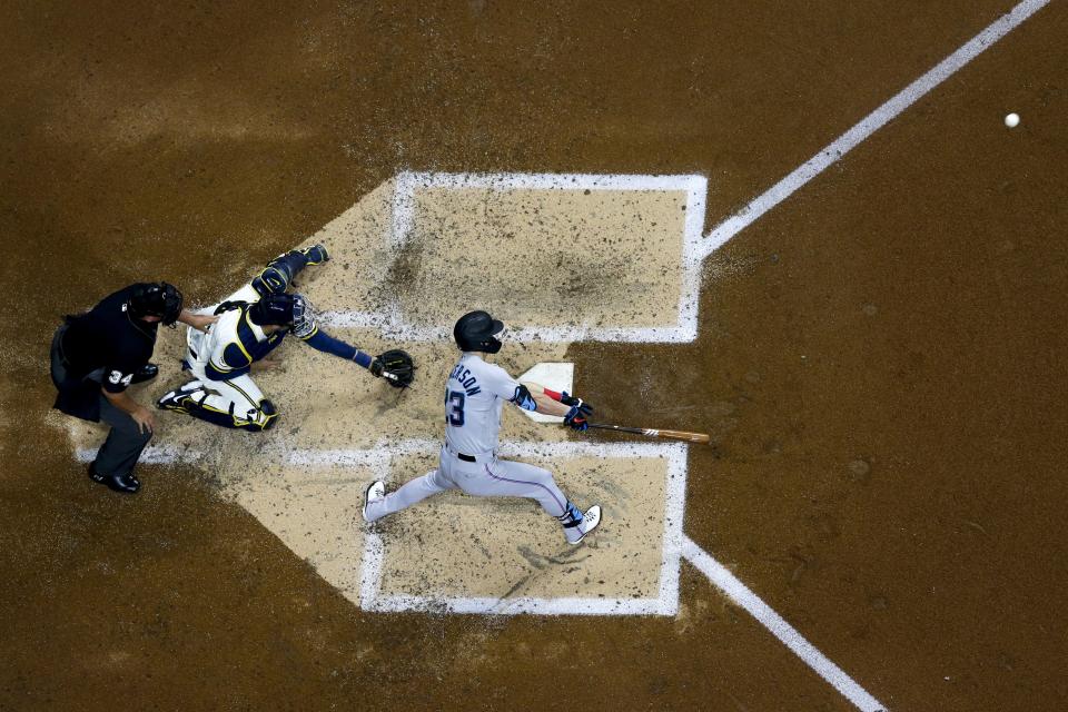 Miami Marlins' Corey Dickerson hits an RBI double during the fourth inning of a baseball game against the Milwaukee Brewers Monday, April 26, 2021, in Milwaukee. (AP Photo/Morry Gash)
